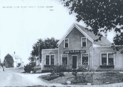 The Yale Shop on Bailey Island. This shop is also fondly remembered as Olive Mathieson's store. She had a tea room and a soda fountain in the north end and a grocery story at the south end. The road behind is Rt. 24, the steamboat wharf is in front.
